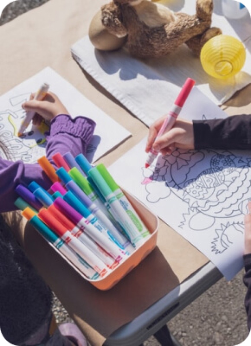 Two children coloring with bright markers