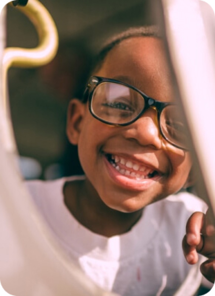 A joyful child in glasses smiling